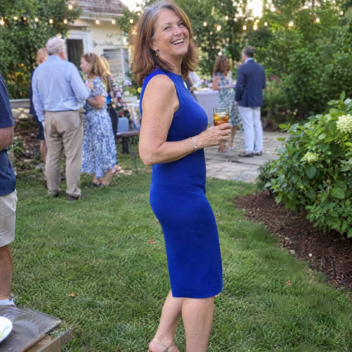 No thigh rub at a summer garden party in a cobalt dress