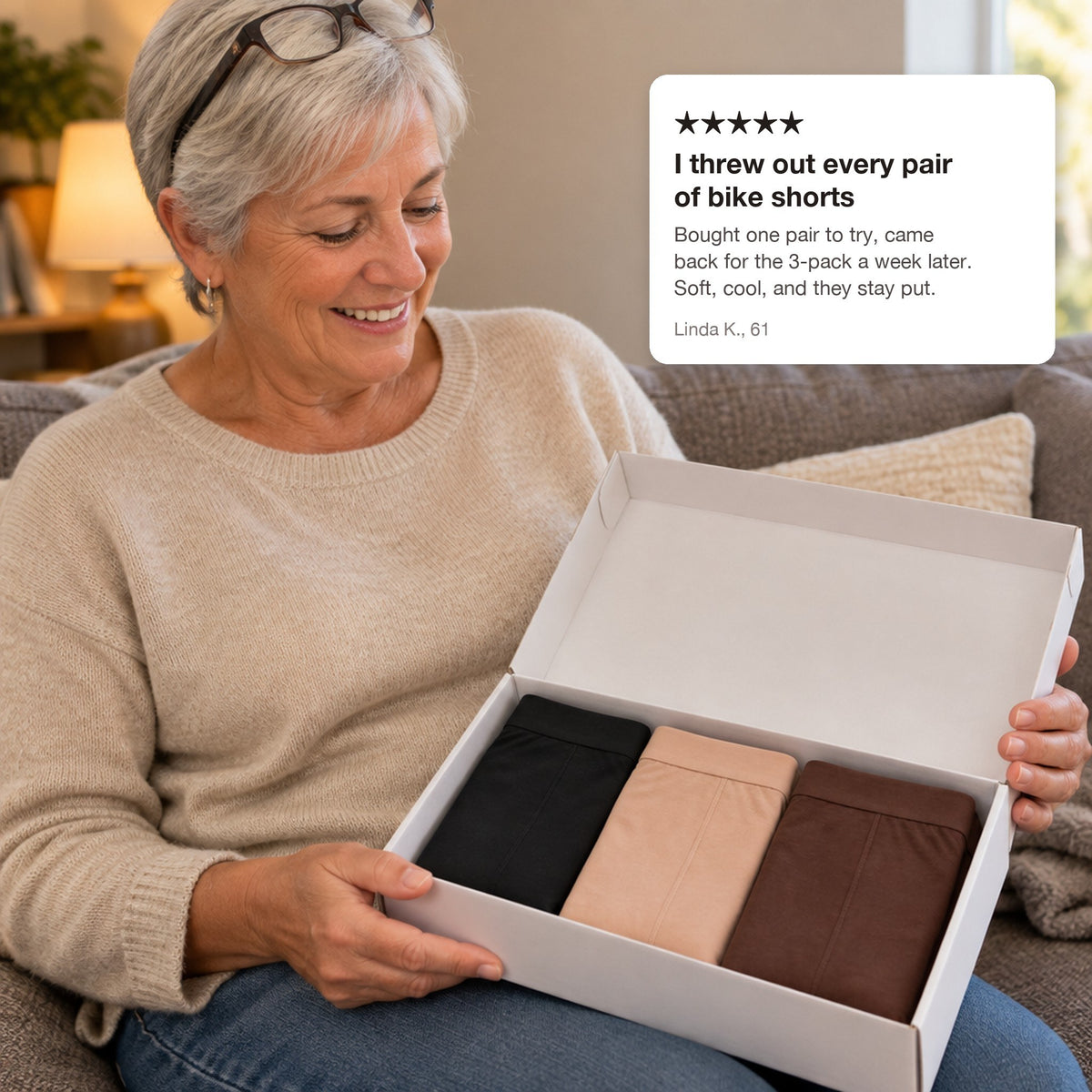 Woman holding a box of three boxers with a review